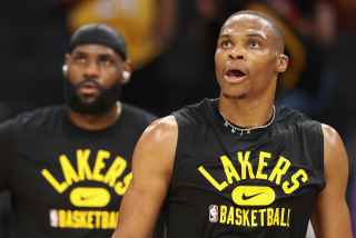 PHOENIX, ARIZONA - OCTOBER 06: Russell Westbrook #0 and LeBron James #6 of the Los Angeles Lakers warm up.