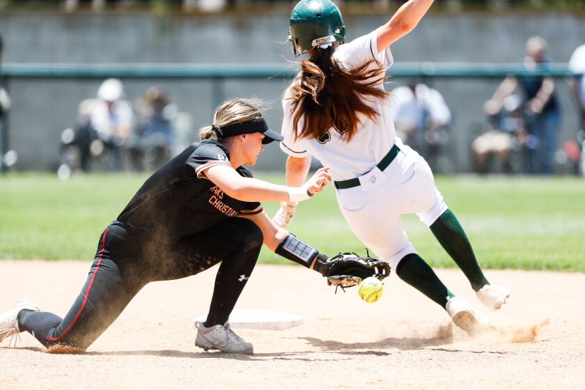 Poway's Alexis Huey (17) evades Oaks Christian's Kamryn Guthrie (8) tag at second base during the Division 1 Southern California regional title game at the school on Saturday, June 3, 2023 in Poway, CA.