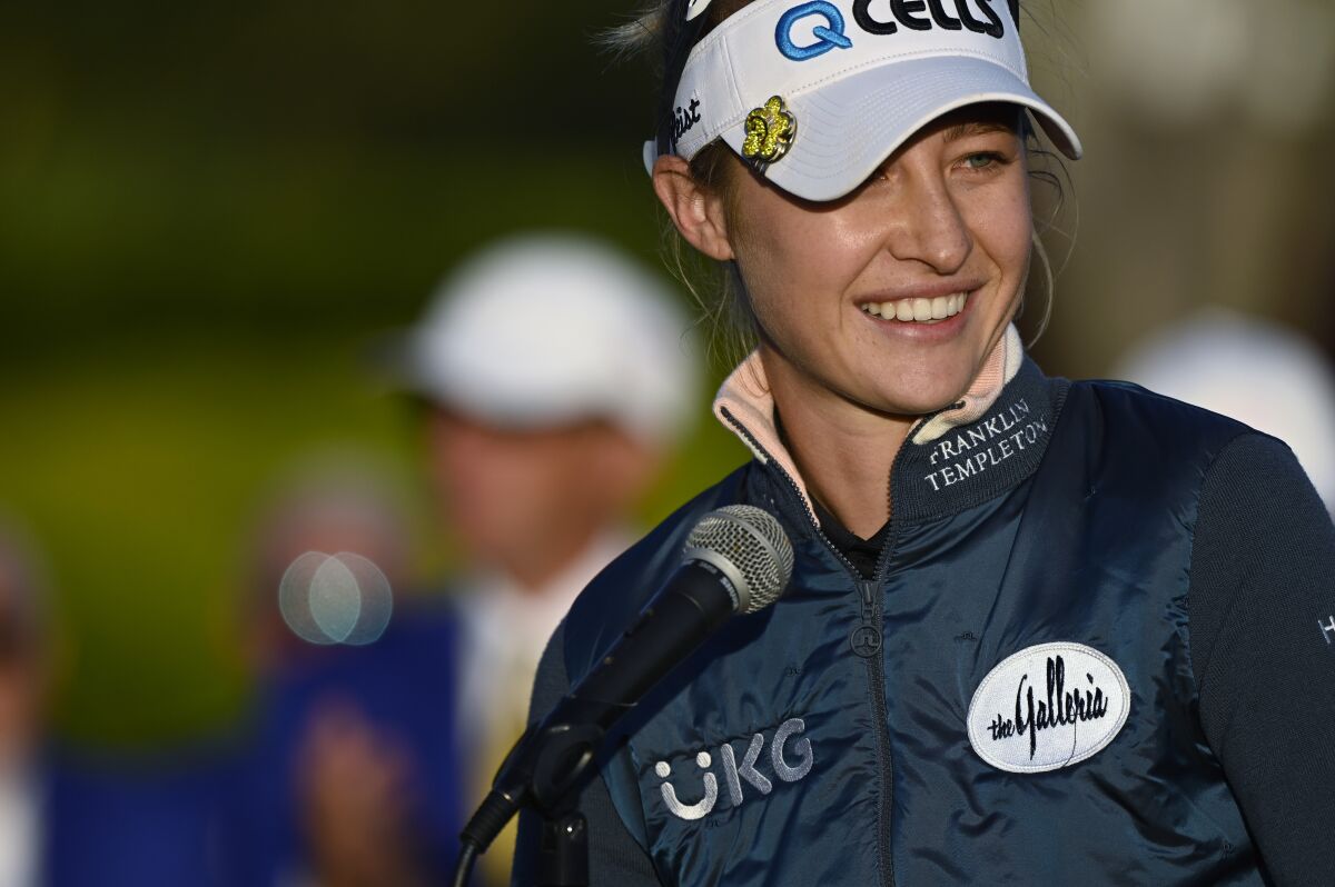 Nelly Korda talks to the crowd gathered at the 18th green after winning the LPGA Pelican Women's Championship golf tournament at Pelican Golf Club, Sunday, Nov. 14, 2021, in Belleair, Fla. (AP Photo/Steve Nesius)