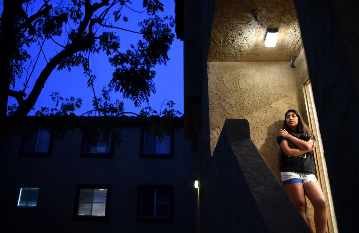 Melanie Santos, outside her Pico Rivera apartment, has lost work as a substitute teacher.