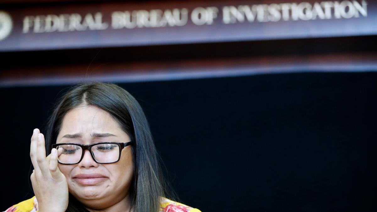 Dysabel Munguia cries as she speaks during a news conference to announce the addition of fugitive Jesus Roberto Munguia to the FBI's most-wanted list Monday.