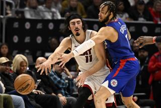 Heat guard Jaime Jaquez Jr. passes the ball away from Clippers guard Amir Coffey 