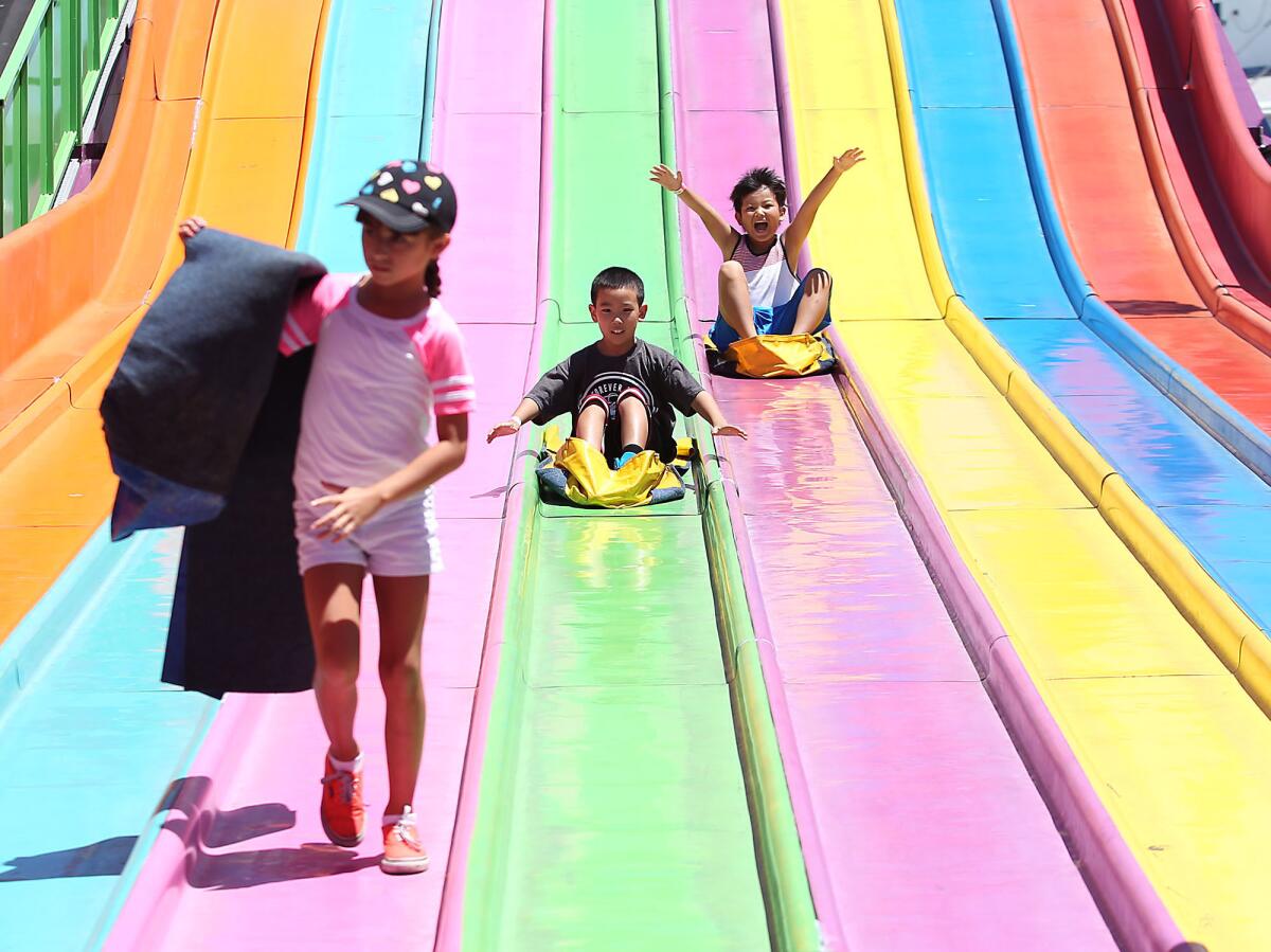 Kids enjoy the giant bean bag slide at the 2015 Orange County Fair.