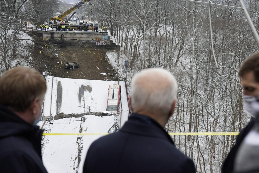 President Joe Biden visits the site where the Fern Hollow Bridge collapsed Friday, Jan. 28, 2022, in Pittsburgh's East End. (AP Photo/Andrew Harnik)
