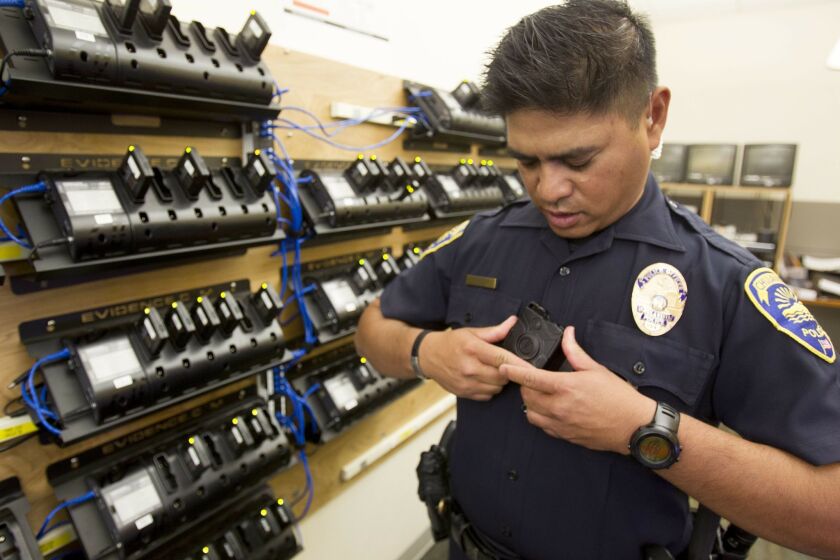 Chula Vista Police Department is one of the agencies in San Diego County using cameras while they are out on calls. The camera is mounted in the front of the officers uniform and has a fisheye camera lens. Officers turn the camera on at their discretion. In the charging room, officer Alan de la Pena reattaches the camera to the mount.