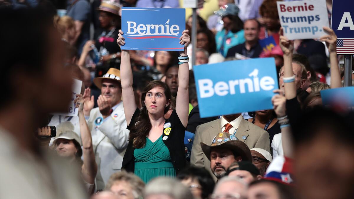 Supporters of Bernie Sanders hold up signs at the Democratic National Convention in Philadelphia.