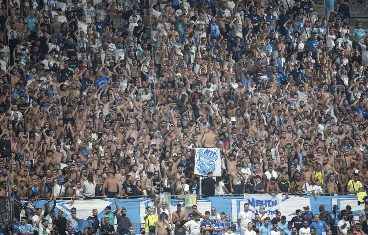 Soccer fans prior to the French League One soccer match between Marseille and Saint-Etienne at the Velodrome stadium in Marseille, southern France, Saturday, Aug. 28, 2021. (AP Photo/Daniel Cole)