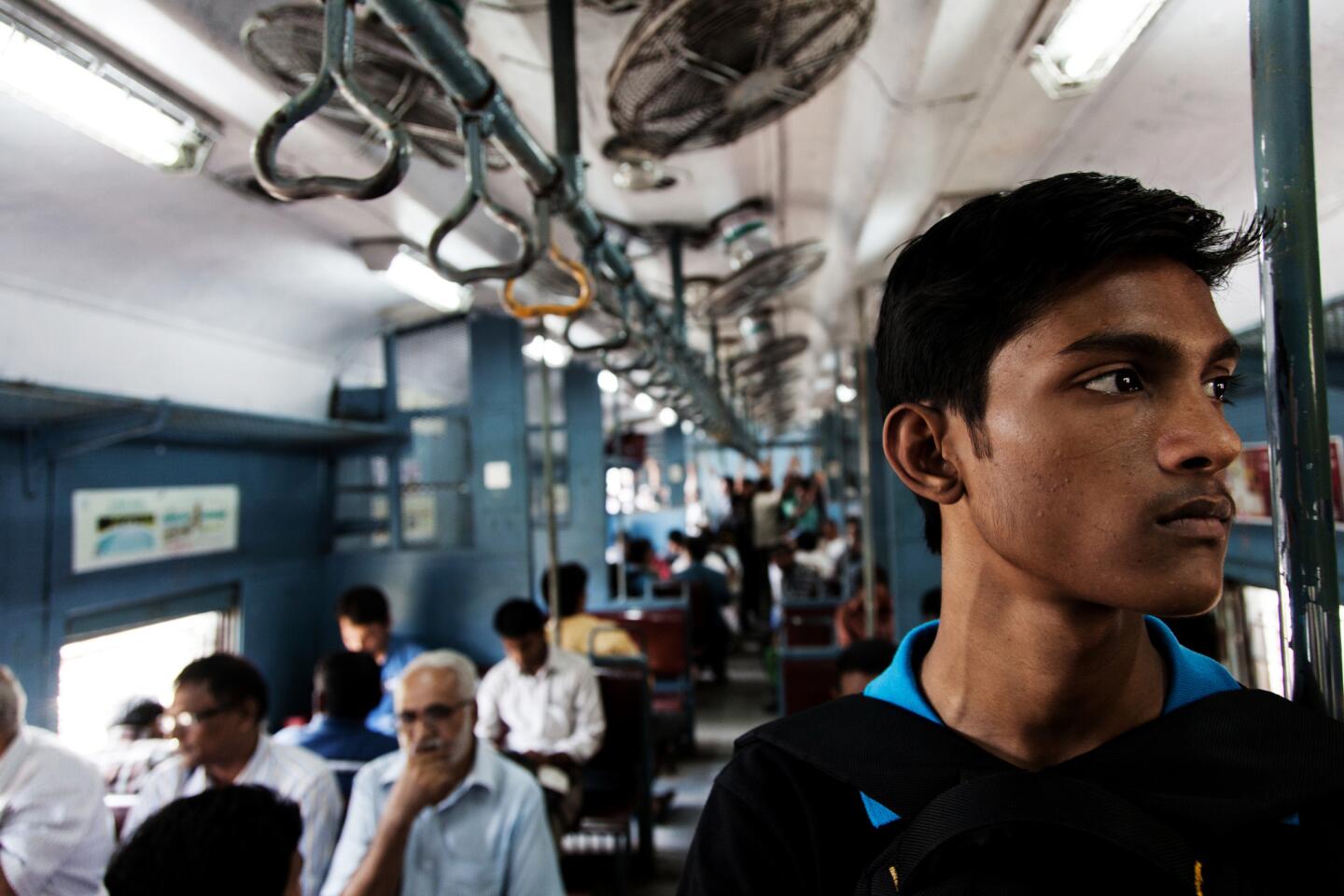 Aditya Giri, 19, of Mumbai takes a train to make a package delivery. He works for the startup Get My Peon, which takes care of mundane tasks for clients.