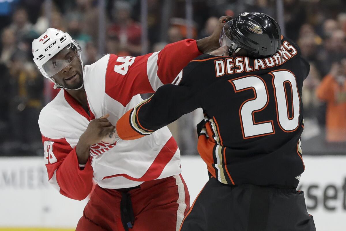 Detroit Red Wings' Givani Smith, left, fights with Ducks left wing Nicolas Deslauriers during the first period on Tuesday at Honda Center.
