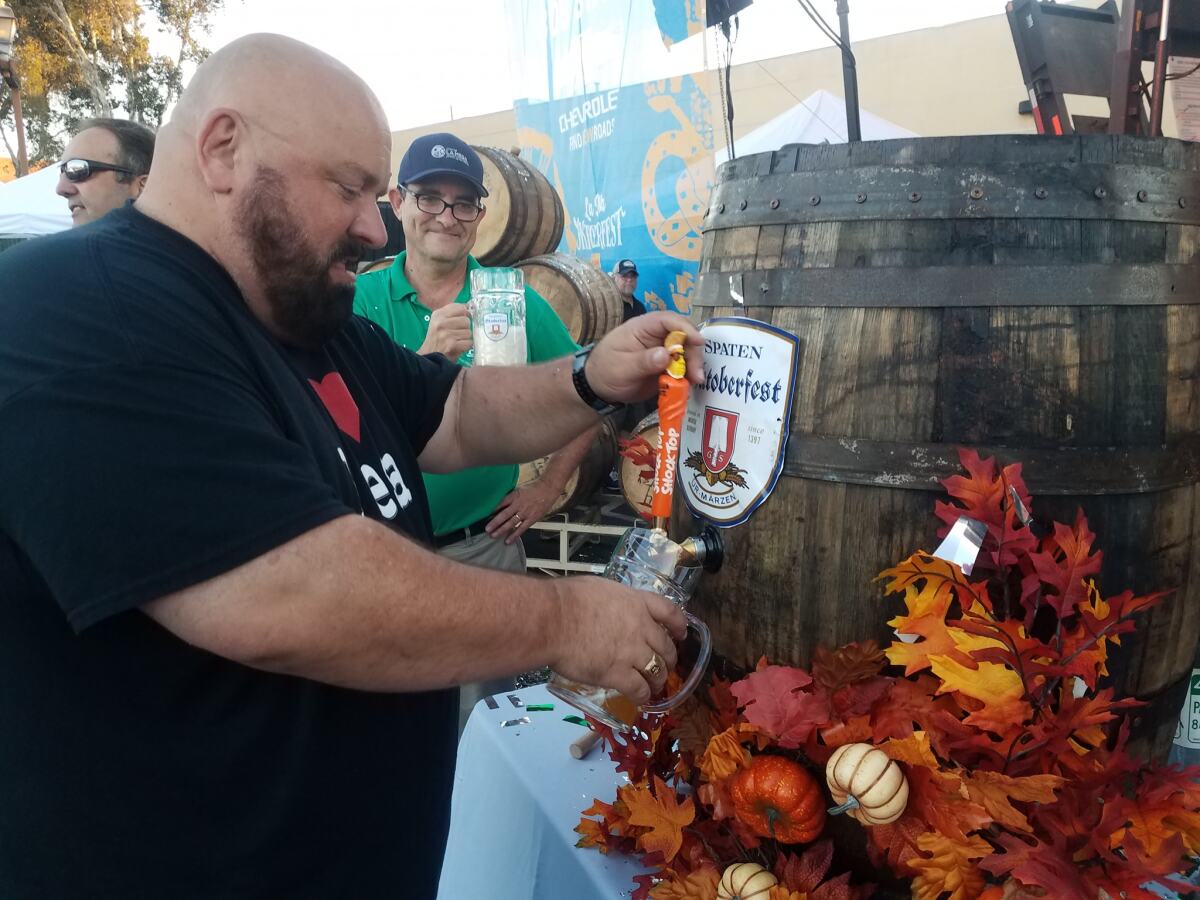 La Mesa Mayor Mark Arapostathis taps the keg at the 2018 La Mesa Oktoberfest.