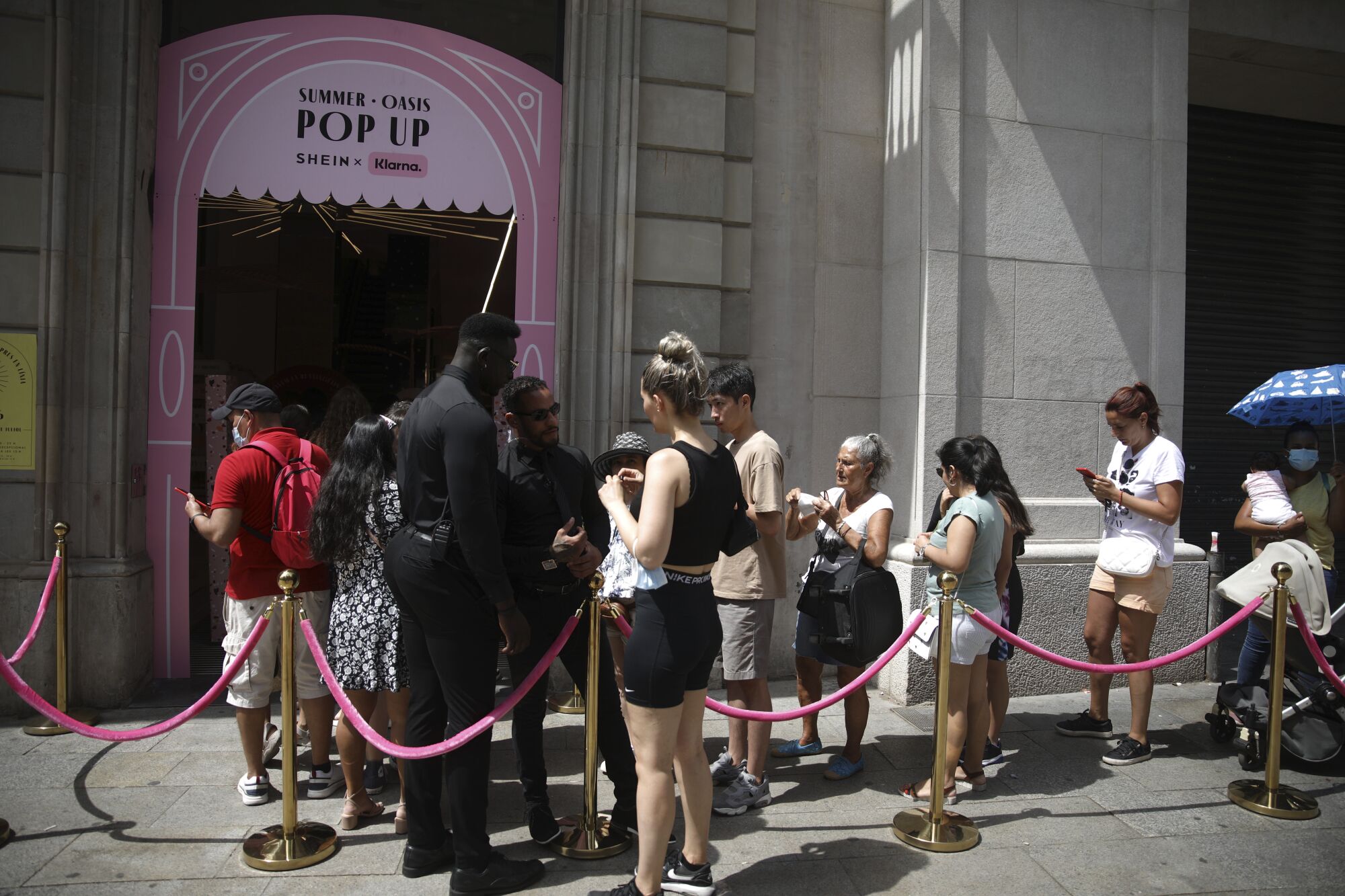 People waiting in line to enter a Shein pop-up store in Barcelona, Spain