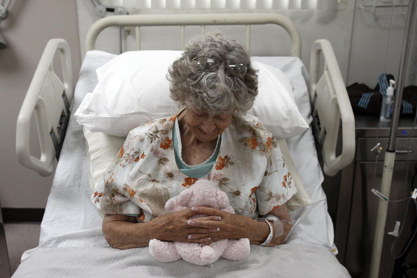 Jennie Guard, 73, cuddles a stuffed animal during taping of the new television series "Getting On" at St. Luke Medical Center in Pasadena. "Getting On," a new HBO comedy from the creators of "Big Love," casts a wry eye on the business of old age and death in an extended-care facility in Long Beach.