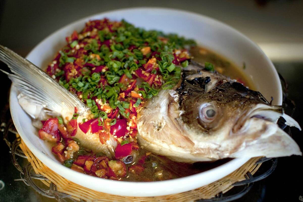 Steamed fish head in a chile-laden broth is favorite at Hunan Mao in Rosemead.
