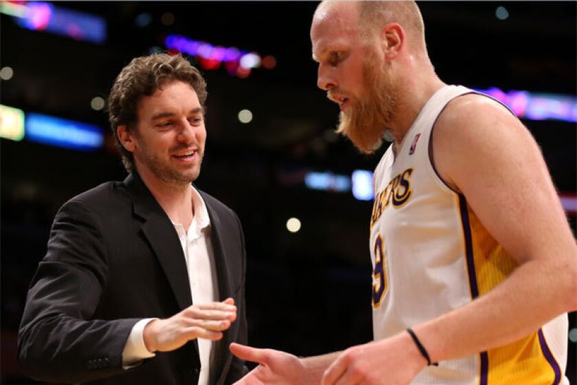 Pau Gasol greets Chris Kaman as he comes out of a game against the Phoenix Suns at Staples Center.