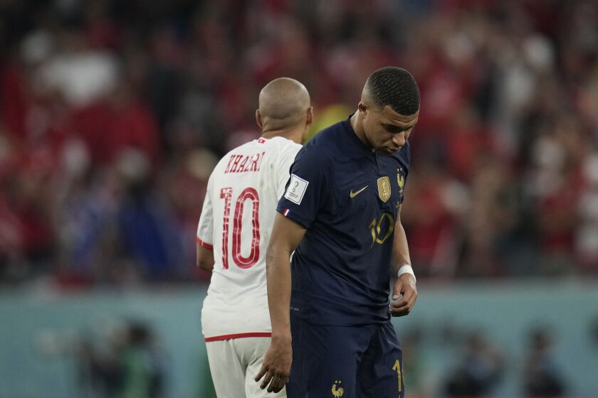France's Kylian Mbappe, right, and Tunisia's Wahbi Khazri leave after the World Cup group D soccer match between Tunisia and France at the Education City Stadium in Al Rayyan , Qatar, Wednesday, Nov. 30, 2022. Defending champion France won its World Cup group despite losing to Tunisia 1-0. (AP Photo/Christophe Ena)