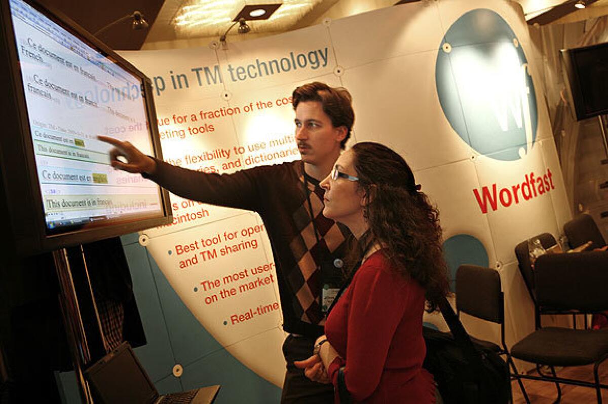 John Di Rico of France shows New Yorker Nicole Efros the Wordfast translation software, a computer assistance program, at the American Translators Assn. convention held in Manhattan recently.