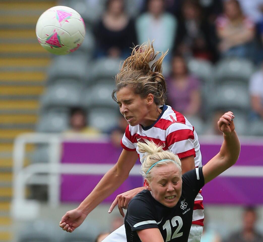 U.S. forward Alex Morgan, top, wins a header over Betsy Hassett of New Zealand during their quarterfinal match at the 2012 Summer Olympics.