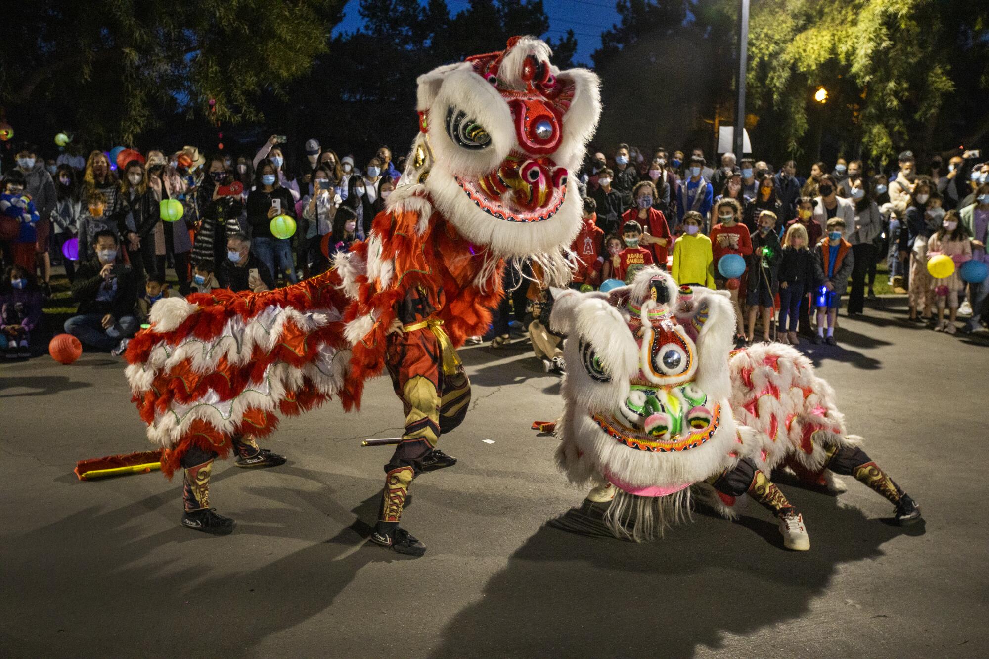 The Qing Wei Lion and Dragon Dance Cultural Troupe performs a lion dance in Ladera Ranch