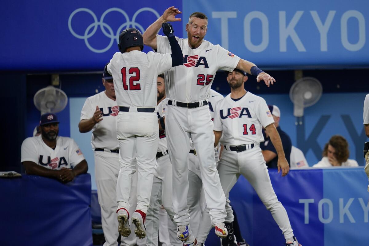 Jamie Westbrook celebrates his home run with U.S. teammate Todd Frazier.