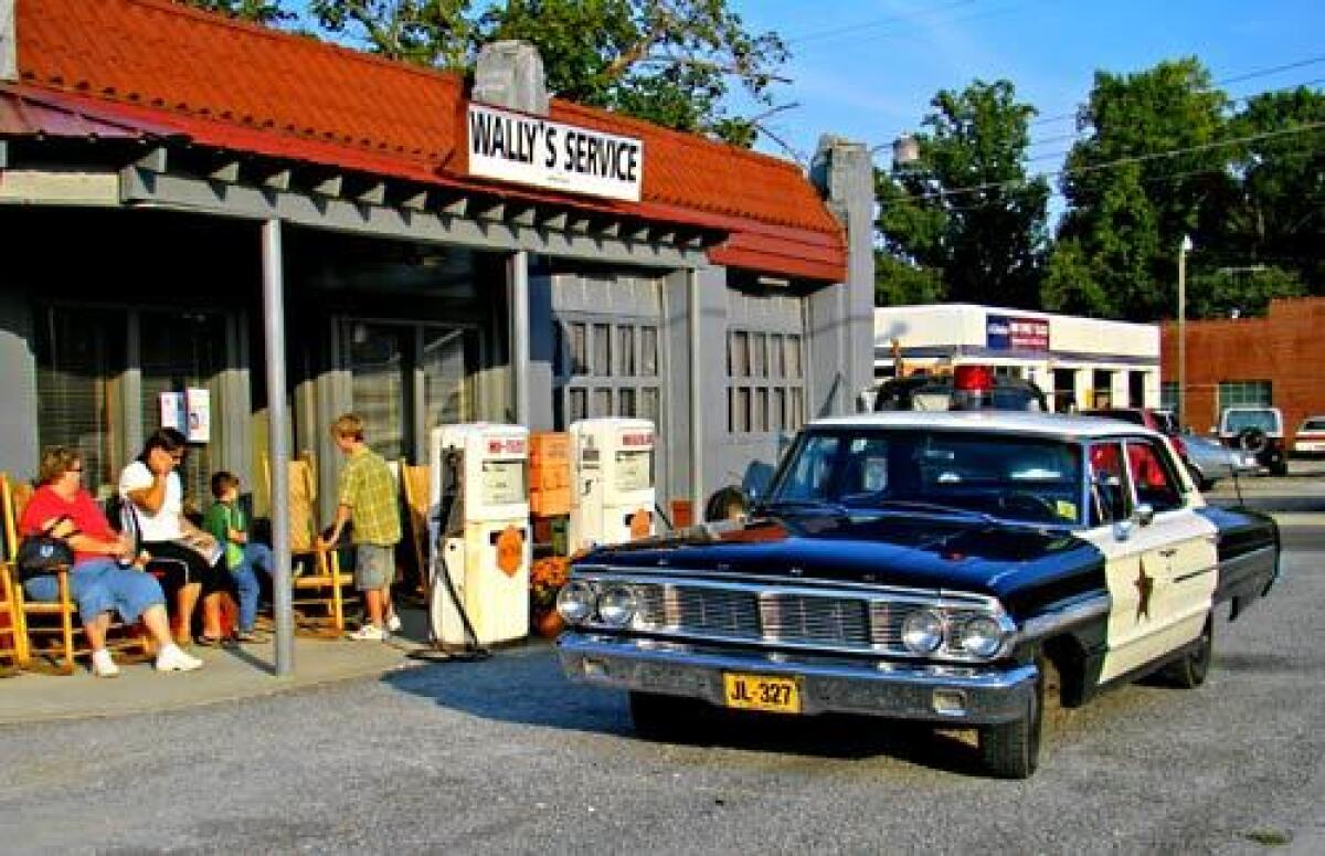 TIME WARP: Tours in vintage police cruisers, like the ones used in the 1960s TV sitcom, depart from Wally's Filling Station. The town holds a Mayberry Days festival each September.
