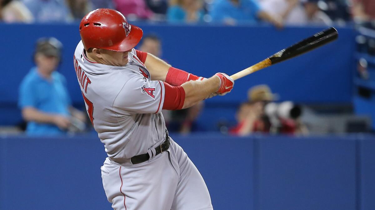 Angels designated hitter Mike Trout hits a run-scoring double during the fifth inning of the team's 9-3 win over the Toronto Blue Jays on Sunday.