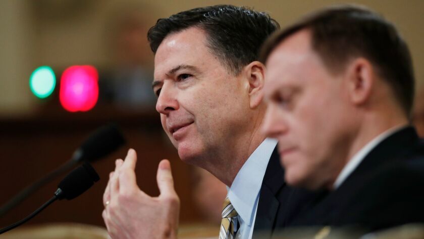 FBI Director James Comey, left, with National Security Agency Director Michael Rogers, right, testifies in Washington, on Monday before the House Intelligence Committee hearing on allegations of Russian interference in the 2016 U.S. presidential election.