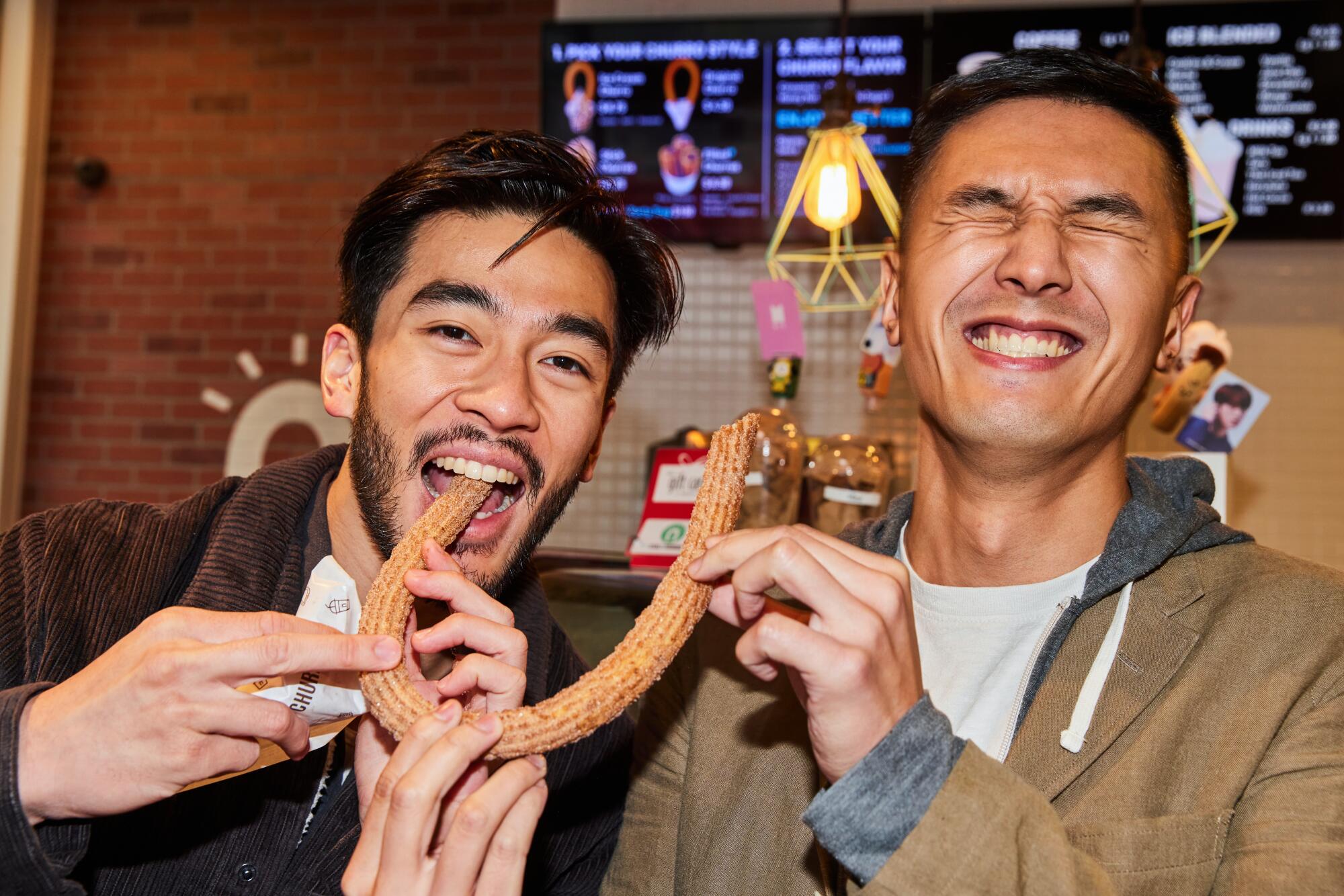 Justin Chien and Byron Wu share a churro.