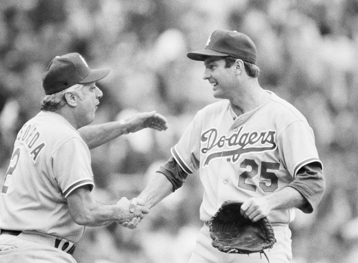 Dodgers manager Tom Lasorda congratulates Tommy John on the mound during the 1978 playoffs 