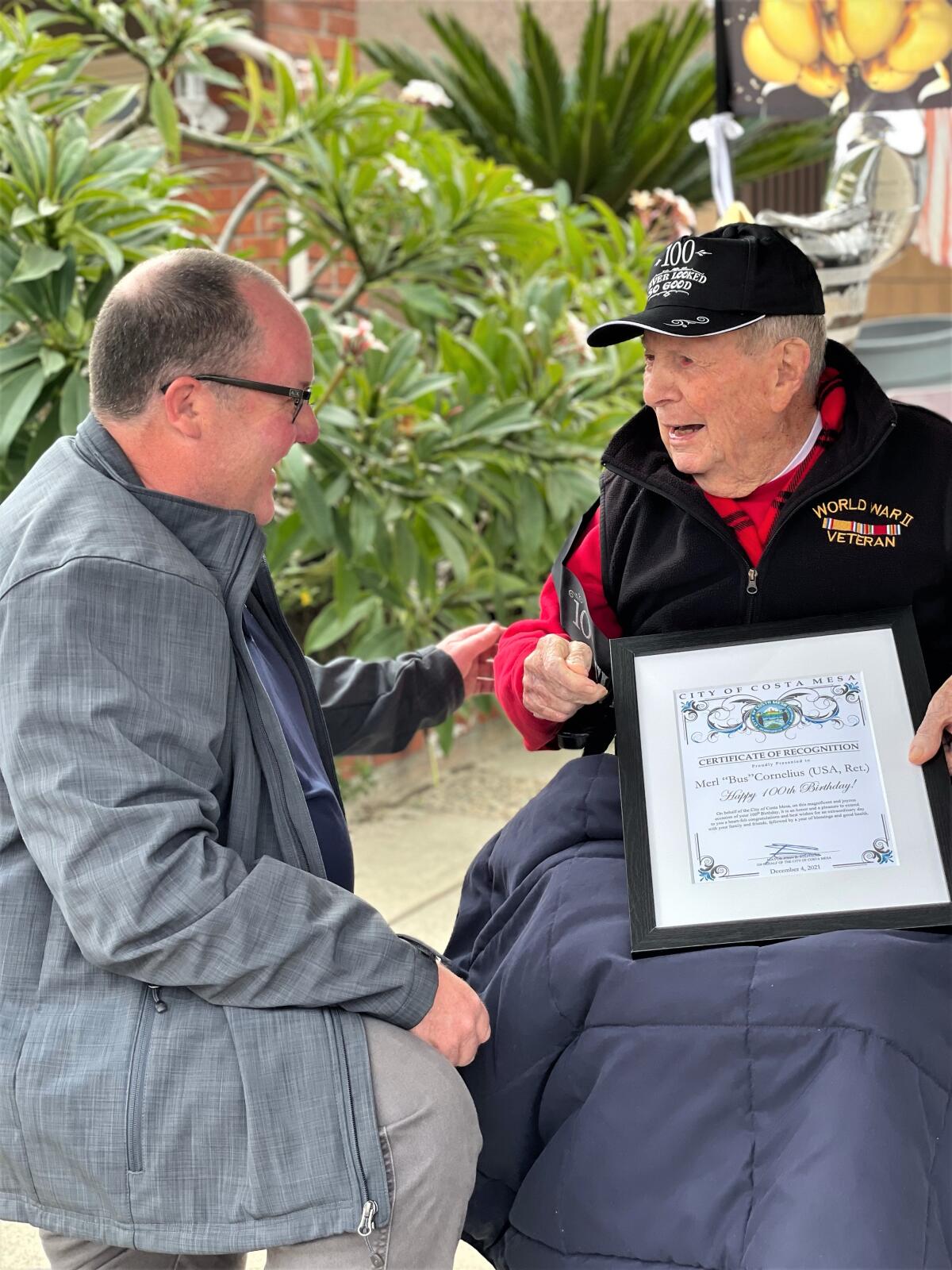 Costa Mesa Mayor John Stephens, left, presents a proclamation to 100-year-old resident Merl "Bus" Cornelius on Saturday.