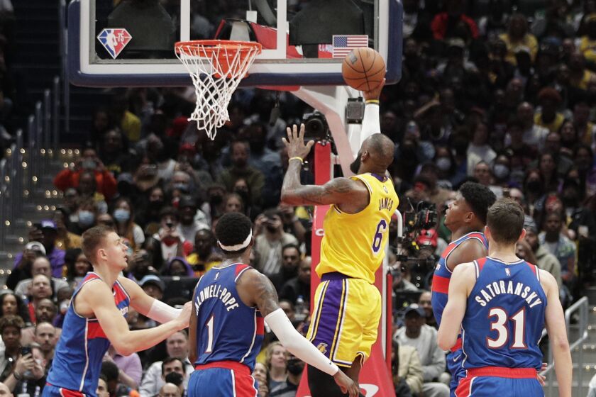 The Lakers' LeBron James scores against the Wizards on March 19, 2022, in Washington.
