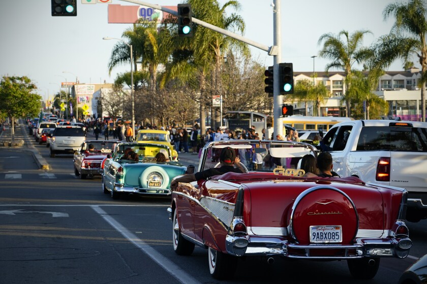 Customized lowriders cruise down Highland Avenue on Friday in National City.