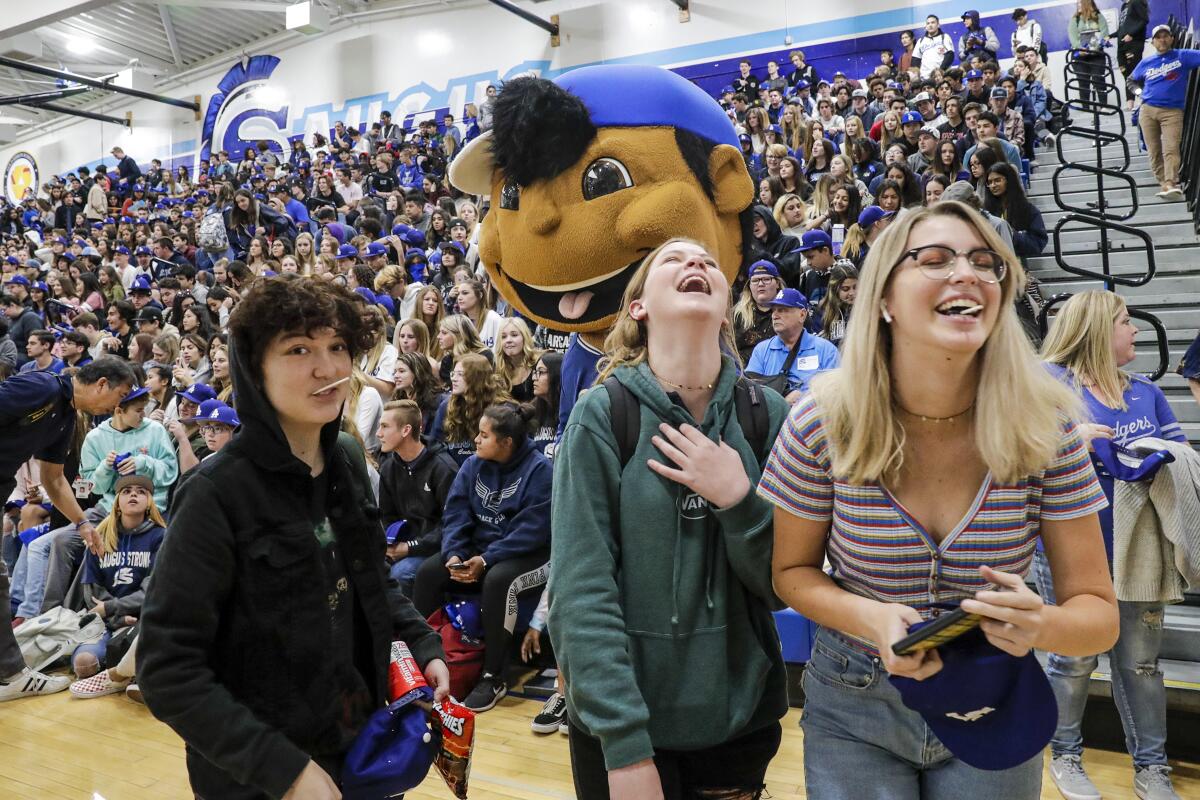 Students give a warm welcome to Dodgers players at Saugus High School during a school pep rally Friday.