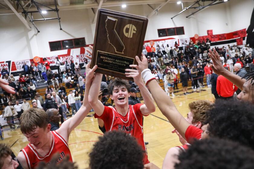 CORONA , CA - MARCH 07: Harvard-Westlake basketball team celebrate after winning the Southern California Open Division regional final against Corona Centennial 80-61 on Tuesday, March 7, 2023 in Corona, CA. (Jason Armond / Los Angeles Times)