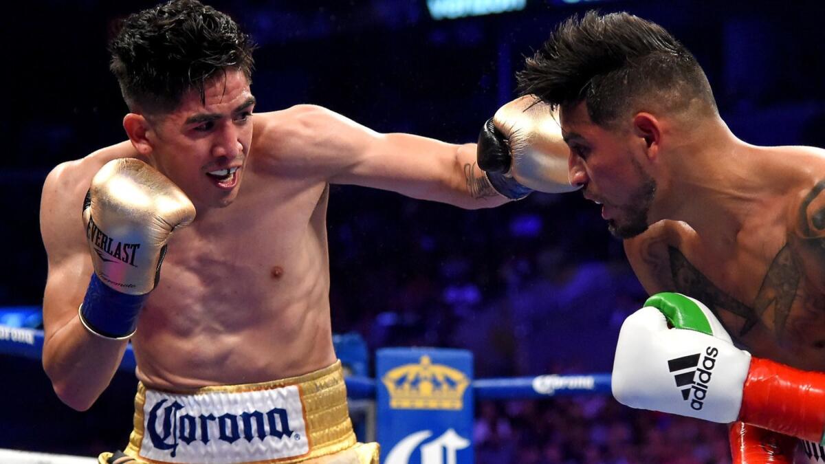 Leo Santa Cruz lands a jab against Abner Mares during their WBA featherweight title at Staples Center on June 9, 2018.
