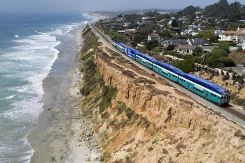 A train travels along the collapsing bluffs in Del Mar.