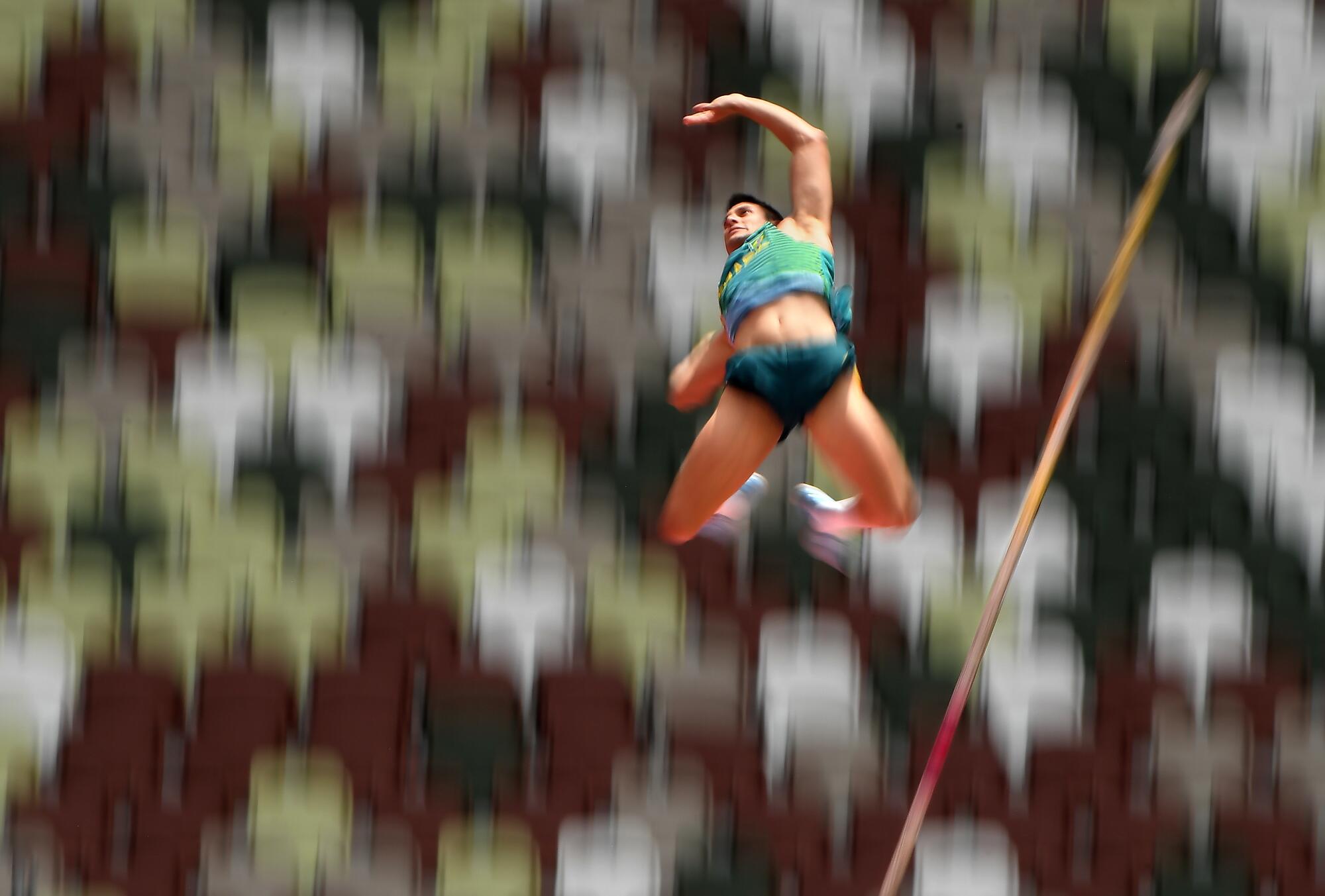 Augusto Dutra of Brazil pole-vaults at the Tokyo Olympics.