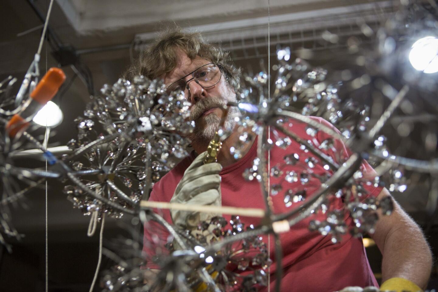 David Hollen works on a piece titled "Tetrahedral Chain" in the basement of his apartment building on East 3rd Street where he has lived and worked since 2005. "This area was doomed the moment they declared it 'the Arts District,' " Hollen said. "Like moths to a flame, developers are drawn to artist enclaves as a sure-fire way to make a lot of money."