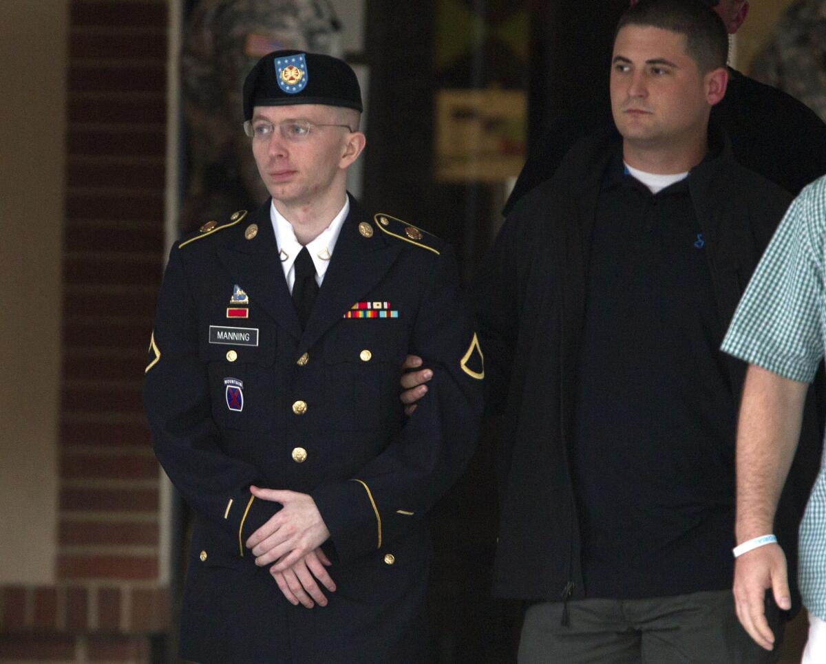 Army Pfc. Bradley Manning is escorted out of a courthouse in Ft. Meade, Md.