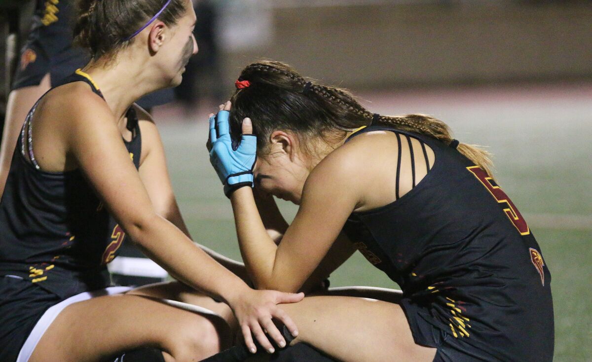 A teammate consoles Falcon junior Lucie Schroeder following Saturday's tough loss.