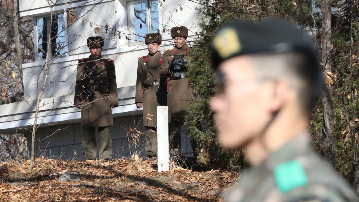 North Korean soldiers and a South Korean soldier, right, in the Demilitarized Zone on Nov. 27.
