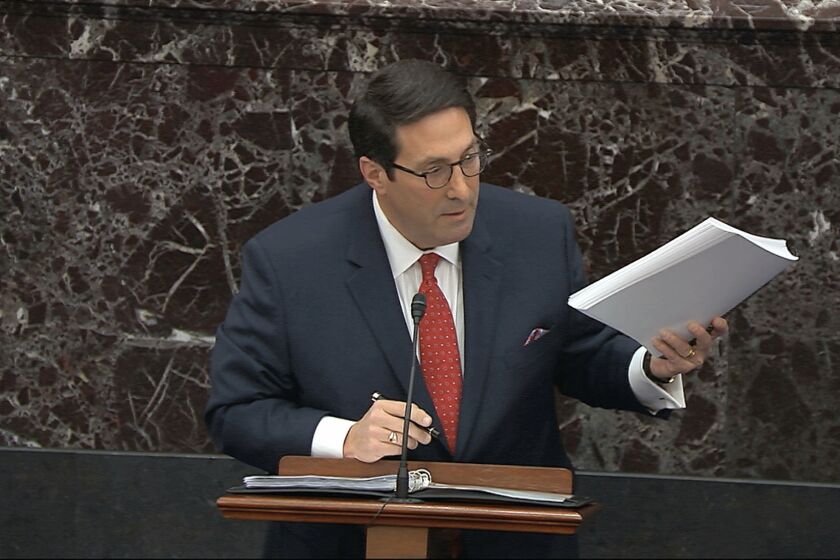 In this image from video, personal attorney to President Donald Trump, Jay Sekulow, hold a copy of the Mueller Report as speaks during the impeachment trial against Trump in the Senate at the U.S. Capitol in Washington, Saturday, Jan. 25, 2020. (Senate Television via AP)