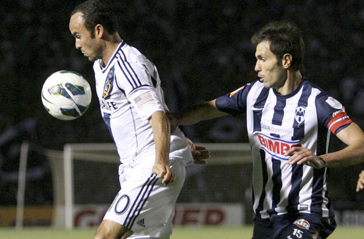 Galaxy midfielder Landon Donovan controls the ball under pressure from Monterrey's Jose Maria Basanta during a CONCACAF Champions League semifinal game earlier this month.