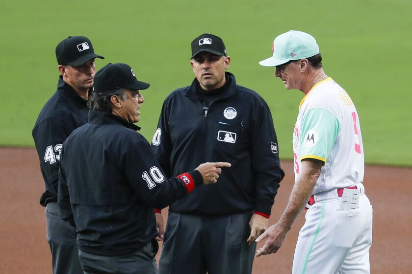 Padres manager Bob Melvin (3) talks to the umpires after the first inning during Friday's game at Petco Park.