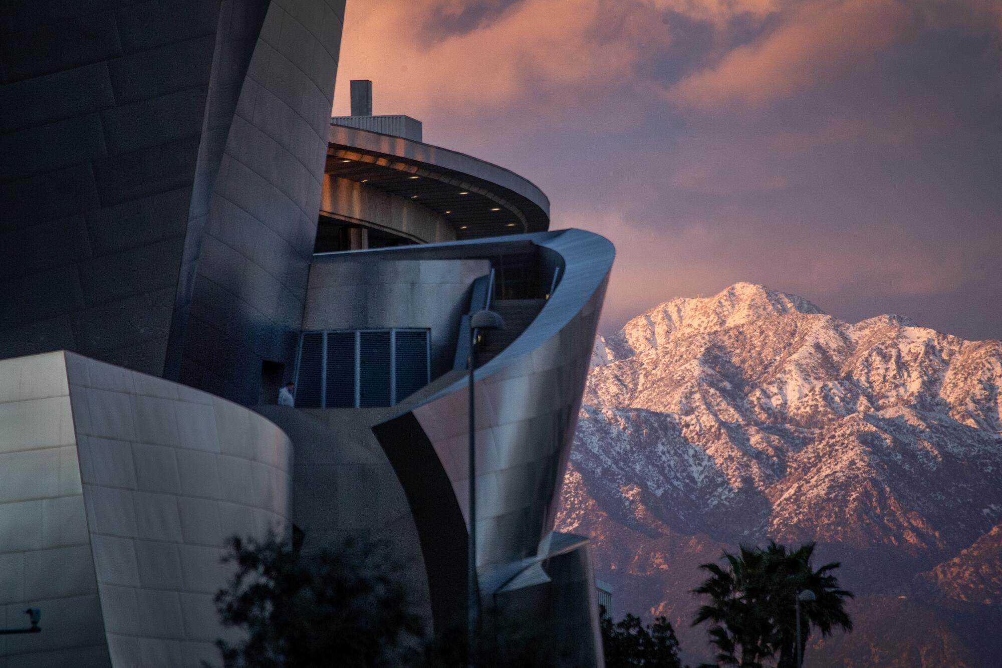 A view of snow-capped San Gabriel Mountains seen at sunset from the Walt Disney Concert Hall in downotwnLos Angeles.