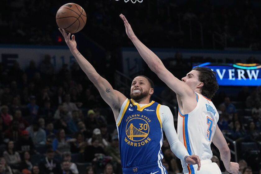 Warriors guard Stephen Curry (30) shoots in front of Oklahoma City Thunder guard Josh Giddey (3) in the first half of an NBA basketball game Monday, Jan. 30, 2023, in Oklahoma City. (AP Photo/Sue Ogrocki)