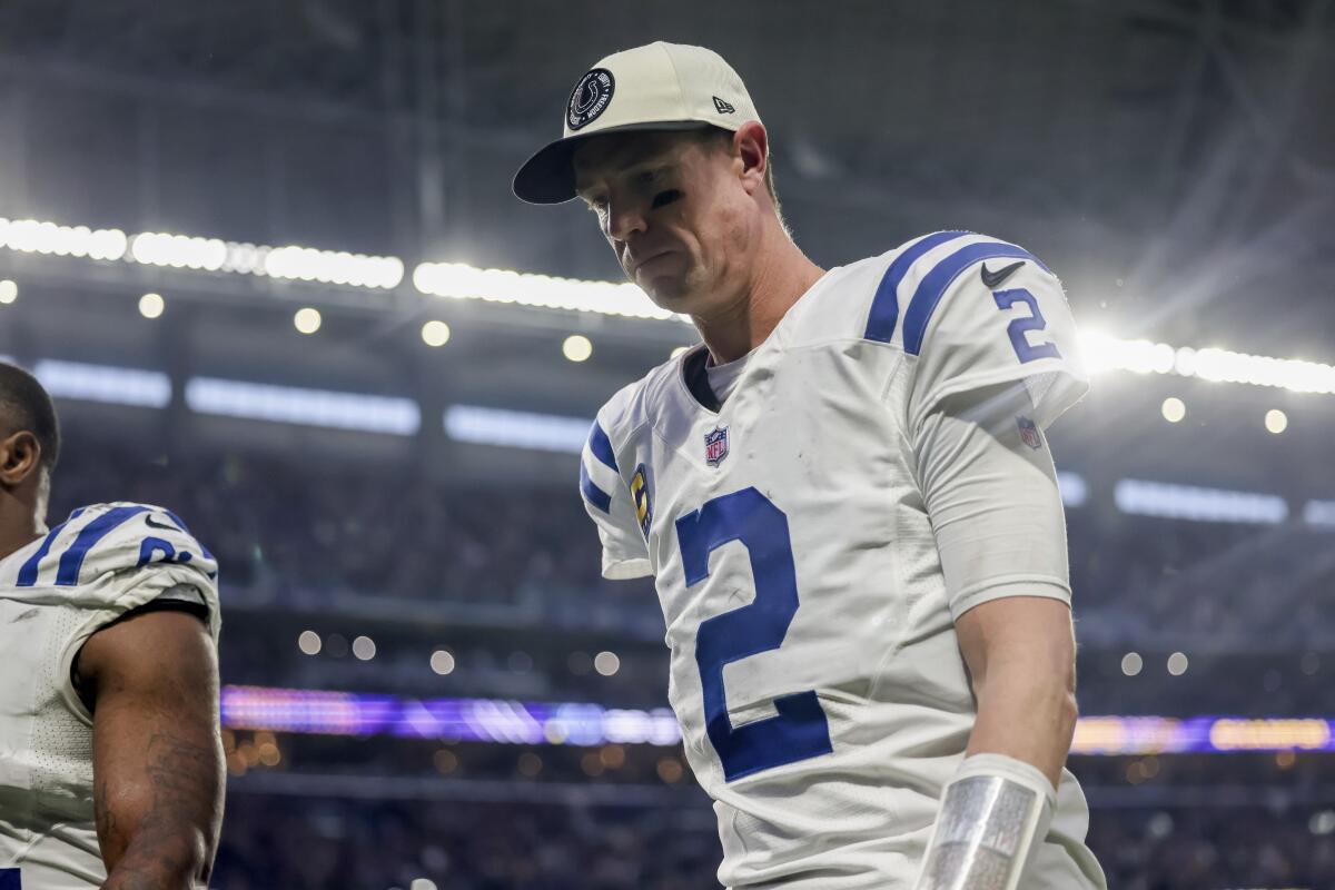 Colts quarterback Matt Ryan walks dejectedly off the field after losing in overtime to the Vikings.
