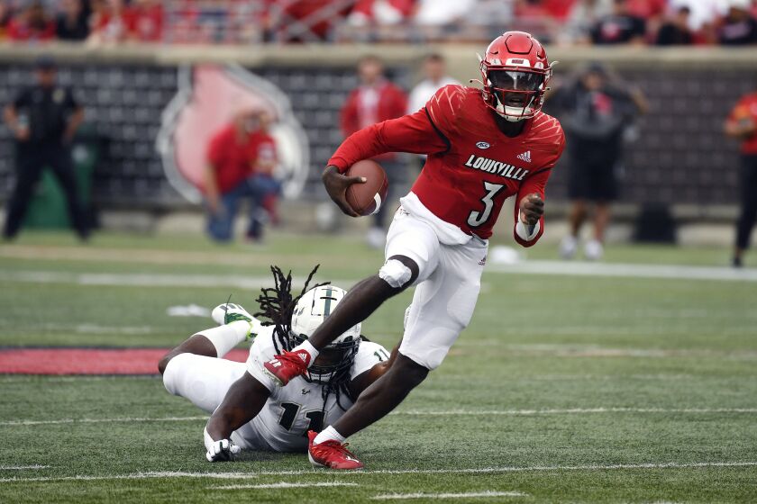 Louisville quarterback Malik Cunningham (3) outruns the diving grasp of South Florida linebacker Dwayne Boyles (11) during the first half of an NCAA college football game in Louisville, Ky., Saturday, Sept. 24, 2022. (AP Photo/Timothy D. Easley)