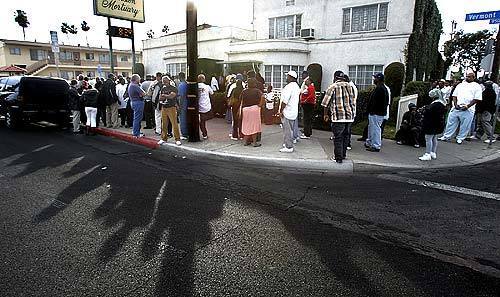Mourners line up outside Winston Family Mortuary in South Los Angeles to pay their respects to Stanley Tookie Williams, the convicted murderer and co-founder of the Crips who was executed last week.