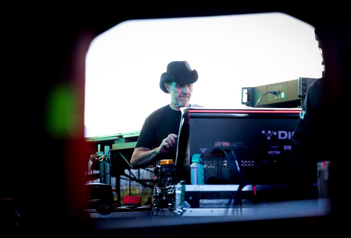 Man in a black cowboy hat at the sound board of the Sahara Tent at Coachella