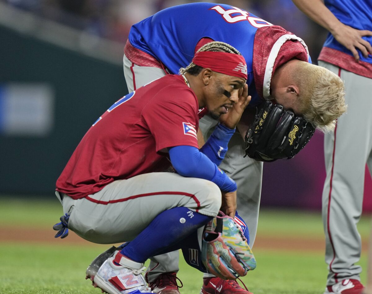 Puerto Rico players react after pitcher Edwin Diaz was injured during a postgame celebration